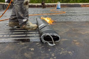 Bituminous membrane waterproofing system details and installation on flat rooftop.